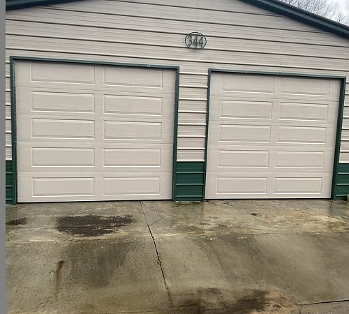  White and green garage with two doors
